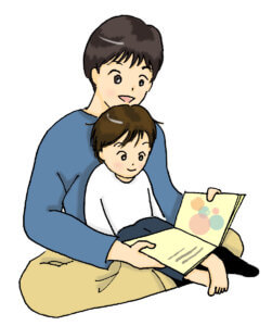 パパに絵本を読んでもらう子供